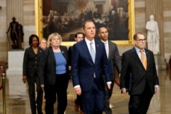 FILE - Impeachment managers walk through rotunda on their way to Senate on Capitol Hill, Jan. 16, 2020.