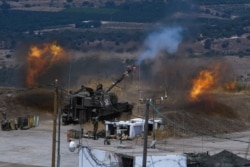 Israeli forces fire artillery on the border with Lebanon after a barrage of rockets were fired from Lebanon, Aug. 6, 2021. The militant Hezbollah group said it fired rockets near Israeli positions close to the Lebanese border.