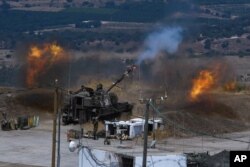 Israeli forces fire artillery on the border with Lebanon after a barrage of rockets were fired from Lebanon, Aug. 6, 2021. The militant Hezbollah group said it fired rockets near Israeli positions close to the Lebanese border.