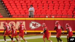 FILE - Kansas City Chiefs players run during NFL training camp at Arrowhead Stadium in Kansas City, Mo., Aug. 29, 2020.