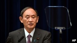 2021 年 8 月 25 日星期三，日本首相菅义伟在东京首相官邸与政府流行病咨询小组主席近江茂（未图示）一起出席新闻发布会。