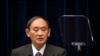 Japan's Prime Minister Yoshihide Suga attends a news conference with chairman of the government's pandemic advisory panel Shigeru Omi, not pictured, at the prime minister's official residence in Tokyo, Wednesday, Aug. 25, 2021. Japan has expanded…