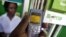 FILE - A man sending money through a mobile phone service called M-Pesa, in Nairobi.