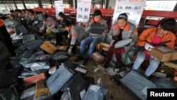 Employees sort packages at Shentong Express delivery company in Anhui province, following China's Singles' Day. It is celebrated annually on November 11 and has become the world's largest online shopping day (Reuters).