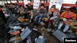 Employees sort packages at a hub of Shentong (STO) Express delivery company in Hefei, Anhui province. China's Singles' Day, which is celebrated annually on November 11, has become the world's largest online shopping day, with online shopping websites offering attractive discounts.