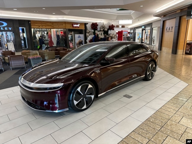 FILE - A 2023 Lucid Air touring sedan sits on display in a mall late Friday, Dec. 15, 2023, in Denver. (AP Photo/David Zalubowski)