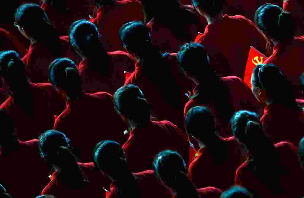 June 30: A performer holds a flag of the Communist Party of China (CPC) during an event to celebrate the upcoming 90th anniversary of the founding of the party. (Reuters/Carlos Barria)