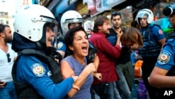 FILE - Turkish police officers arrest protesters, gathered to offer support to workers that were arrested early Saturday for protesting over labor conditions at Istanbul's new airport, in Istanbul, Sept. 15, 2018.