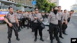 Riot police stand guard outside the General Election Supervisory Board building in anticipation of protests in Jakarta, Indonesia, May 28, 2019.