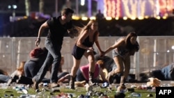 People run from the Route 91 Harvest country music festival after apparent gun fire was hear on Oct. 1, 2017, in Las Vegas, Nevada. 