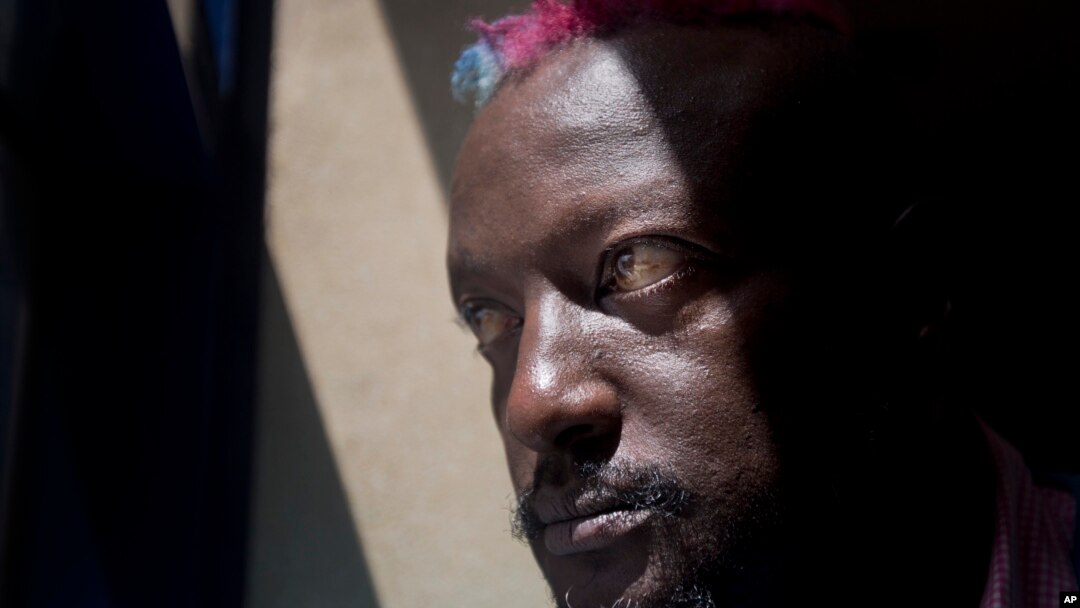 FILE - Prize-winning Kenyan author Binyavanga Wainaina poses for a photograph after giving a television interview in Nairobi, Kenya.