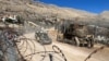 Israeli soldiers ride in a military vehicle along the ceasefire line with Syria and the Israeli-occupied Golan Heights, as seen from the Golan Heights, Dec. 15, 2024. 