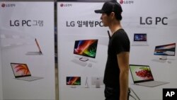A man passes by banners advertising LG Electronics products at a shopping mall in Seoul, South Korea on July 27, 2016.