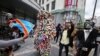 A man marches between two artists dressed in costume as they participate in celebrations marking the 60th anniversary of Congo's independence from Belgium in the Brussels district of Matonge, June 30, 2020. 