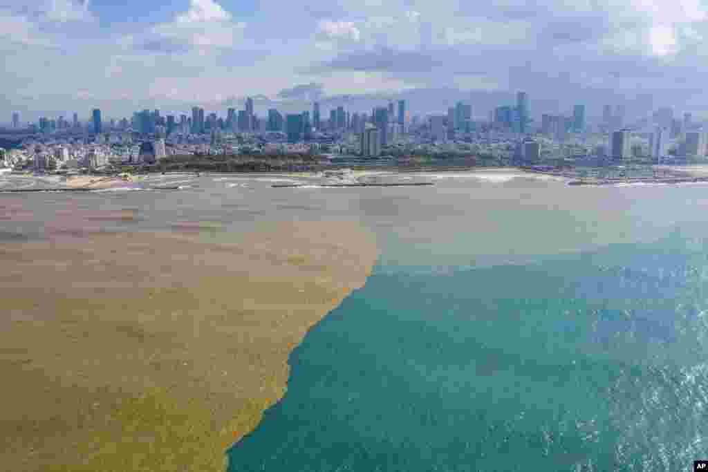 Mud water from Hayarkon river flows in to the Mediterranean Sea in Tel Aviv, Israel.