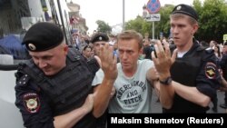 RUSSIA --Policemen detain Russian opposition leader Aleksei Navalny during a rally in support of investigative journalist Ivan Golunov, who was detained by police, accused of drug offense and later freed from house arrest, in Moscow, June 12, 2019.