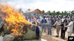 Cambodian officers burn nearly three tones of various drug making substances, which were seized in raids earlier this year in eastern and southern Cambodia.