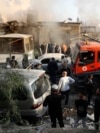 Firefighters and security officers gather at a destroyed building hit in an Israeli airstrike in Damascus, Syria, Nov. 14, 2024. 