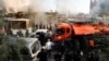 Firefighters and security officers gather at a destroyed building hit in an Israeli airstrike in Damascus, Syria, Nov. 14, 2024. 