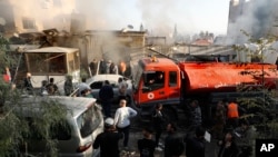 Firefighters and security officers gather at a destroyed building hit in an Israeli airstrike in Damascus, Syria, Nov. 14, 2024. 