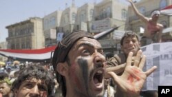 Anti-government protesters shout slogans during a rally to demand the ouster of Yemen's President Ali Abdullah Saleh outside Sanaa University, March 24, 2011