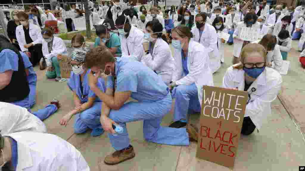 Healthcare workers and medical students mark 8 minutes and 46 seconds of silence in front of the University of Utah Health Sciences Education Building during a demonstration in support of the Black Lives Matter movement, in Salt Lake City, Utah. The period of time is the same length of time that a white policer held his knee on the neck of George Floyd, a black man who died in Minneapolis police custody.&nbsp;(AP Photo/Rick Bowmer)