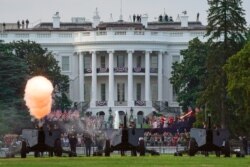 Canons are shot as members of the military parachute onto the Ellipse of the White House during the "Salute to America" event held to celebrate Fourth of July Independence Day in Washington, U.S., July 4, 2020. REUTERS/Sarah Silbiger