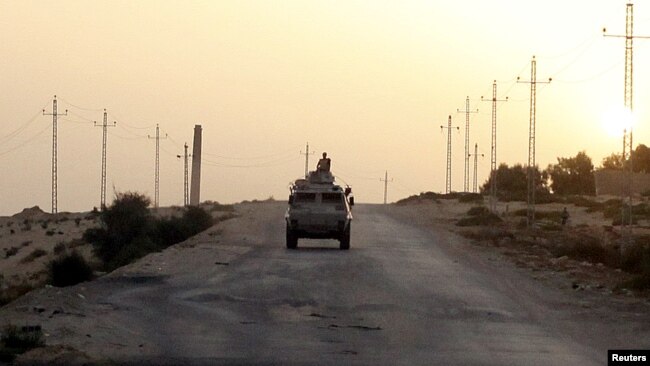 FILE - An Egyptian military vehicle is seen on a                highway in northern Sinai, Egypt, May 25, 2015.