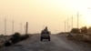 FILE - An Egyptian military vehicle is seen on a highway in northern Sinai, Egypt, May 25, 2015.