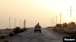FILE - An Egyptian military vehicle is seen on a highway in northern Sinai, Egypt, May 25, 2015. The United States on July 26, 2018, released $195 million in military aid to Egypt that had been withheld over allegations of human rights violations by Egypt's government.