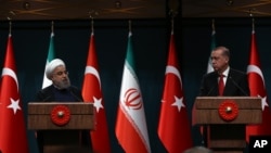 FILE - Iran's President Hassan Rouhani, left, and his Turkish counterpart Recep Tayyip Erdogan speak during a joint news conference in Ankara, Turkey, April 16, 2016. Тhe two countries are now seen as very much on different sides in the Middle East.