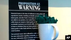 FILE - A posted Proposition 65 warning sign is seen on display at a coffee shop in Burbank, Calif., March 30, 2018.