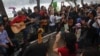 FILE - People sing during a rally protesting against a tree-felling plan by the municipal authorities in Hanoi, March 22, 2015.