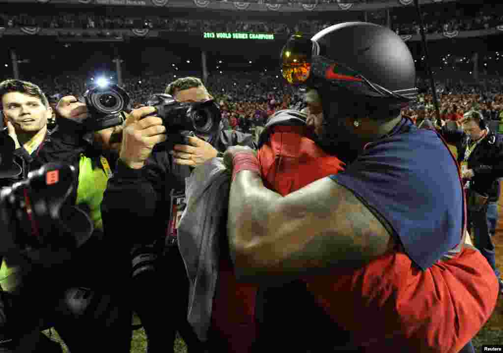 Oct 30, 2013; Boston, MA, USA; Boston Red Sox designated hitter David Ortiz (right) celebrates with starting pitcher Jon Lester after game six of the MLB baseball World Series against the St. Louis Cardinals at Fenway Park. The Red Sox won 6-1 to win the 