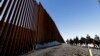 Mounted Border Patrol agents ride along a newly fortified border wall structure, Oct. 26, 2018, in Calexico, California. 