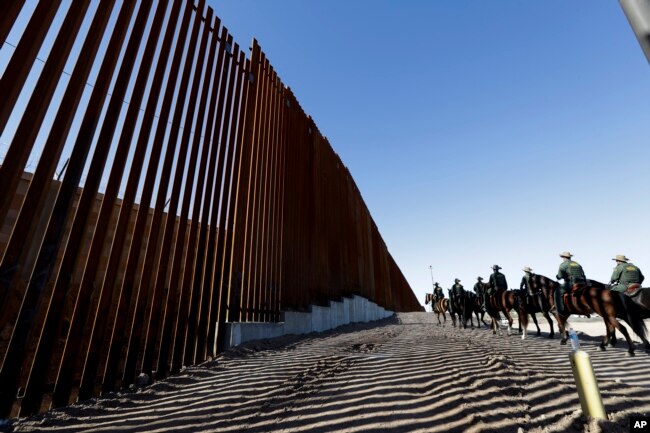 Agentes de la Patrulla Fronteriza viajan a lo largo de una estructura de muro fronterizo recién fortificada, el 26 de octubre de 2018, en Calexico, California.