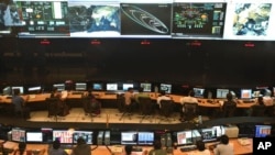 FILE - Indian Space Research Organization (ISRO) scientist and engineers monitor the movements of India's Mars orbiter at their Spacecraft Control Center in Bangalore, India.