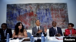 U.S. President Barack Obama attends a meeting with Cuban dissidents at the U.S. embassy in Havana, Cuba, March 22, 2016. On the wall behind Obama is a painting, "My New Friend," donated to the embassy by Michel Mirabal, a Cuban artist.