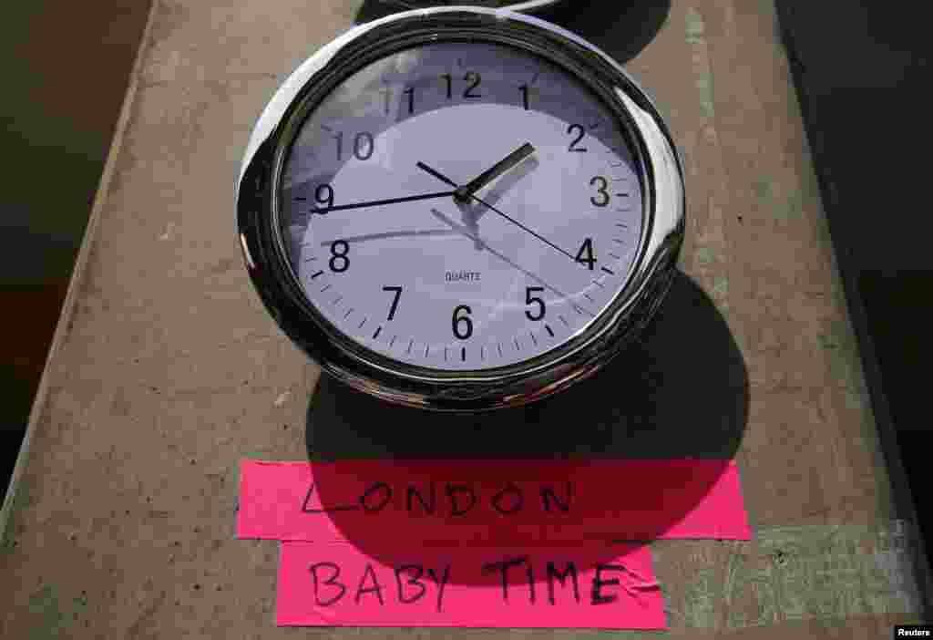 A clock, July 15, 2013, in the press pen shows the time outside the Lindo Wing of St. Mary&#39;s Hospital, where Britain&#39;s Catherine, Duchess of Cambridge, is due to give birth, in London.