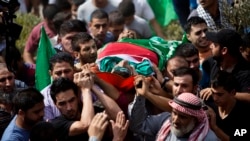 Palestinians carry the body of Huthaifa Suleiman, 18, during his funeral in the Bal'a village near the West Bank city of Tulkarem, Oct. 5, 2015. 