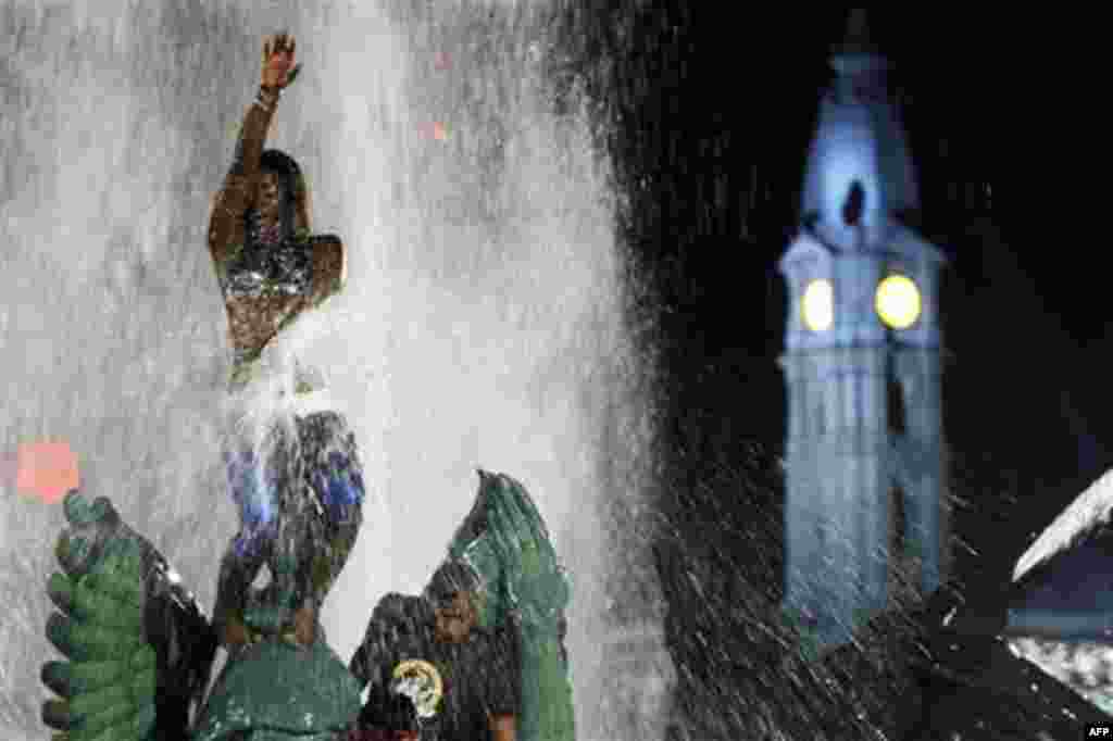 People play in the Swann Memorial Fountain, at Logan Square, in view of City Hall, right, after an Independence Day celebration Monday, July 4, 2011, in Philadelphia. The U.S. celebrated the 235th anniversary of the signing of the Declaration of Independe