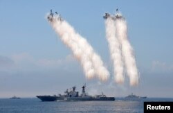 Russian warships sail past exploding anti-missile ordnance during a rehearsal for the Navy Day parade in the far eastern port of Vladivostok, Russia, July 30, 2016.