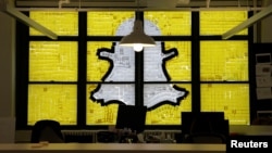 FILE - An image of the Snapchat logo created with Post-it notes is seen in lower Manhattan, New York, May 18, 2016.