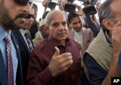 Pakistani opposition leader Shahbaz Sharif, center, who lost election for the premiership of Pakistan, arrives at the National Assembly in Islamabad, Pakistan, Aug. 17, 2018.
