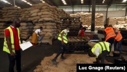 FILE: Workers prepare to quality-control the cashew nuts at a warehouse in Abidjan, Ivory Coast May 13, 2020. Taken May 13, 2020