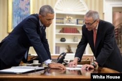 FILE - President Barack Obama meets with John Podesta, Counselor to the President, in the Oval Office, Jan. 29, 2015.