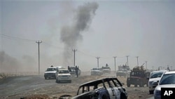 Libyan rebels retreat followed by incoming shells fired by pro-Gadhafi forces along the front line near Brega, Libya, April 5, 2011