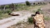 FILE - A ranger from the Kenya Wildlife Service shoots dead a male lion that had strayed from the Nairobi National Park, in Kajiado, Kenya, March 30, 2016. 