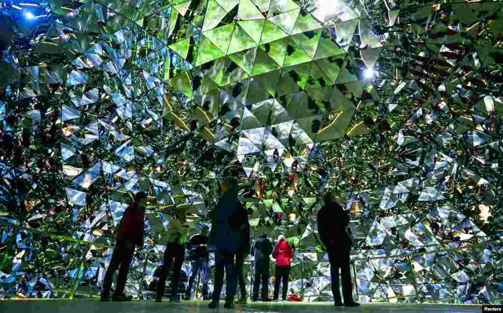 Visitors walk through the Swarowski Crystal World museum on its reopening day following renovation, in the western Austrian village of Wattens.