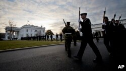 Honor guards from different branches of the U.S. Armed Forces, march on the North Lawn driveway of the White House in Washington, Jan. 15, 2017.